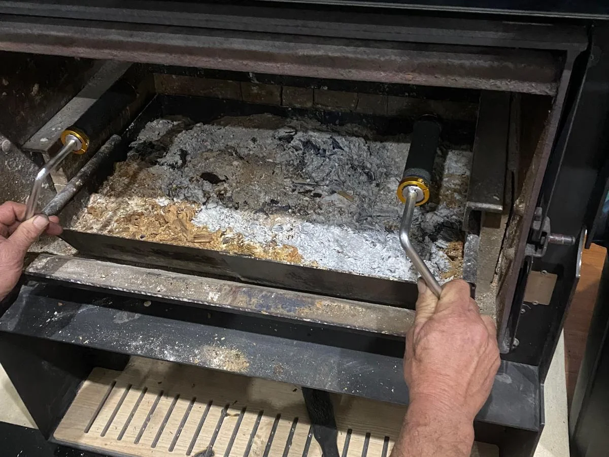 Fireplace tray pulled out showing collected ash